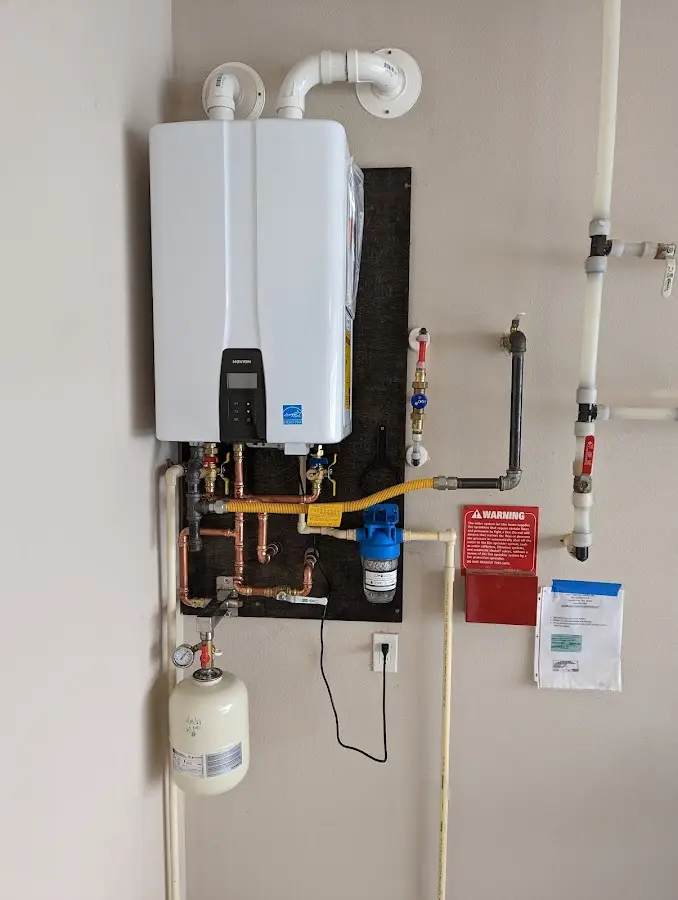 Professional plumber installing copper piping in a Catonsville home